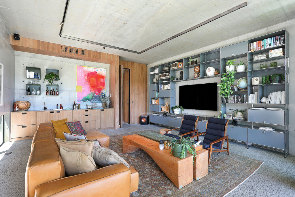 industrial oasis living lounge with tv and artwork